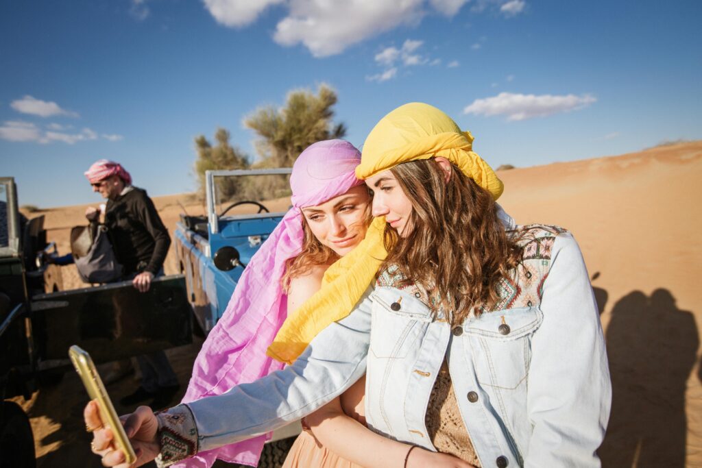 Two Women Wearing Head Scarf Taking Selfie Together